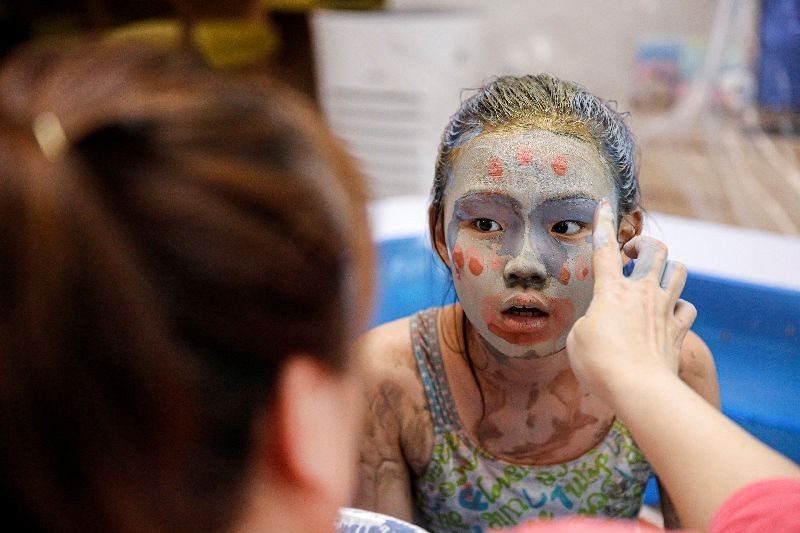 A girl plays in a mud pool during the Online Boryeong Mud Festival at her home during a live streaming event, in Gwangju, Gyeonggi-do, South Korea, July 18, 2020. REUTERS/Heo Ran